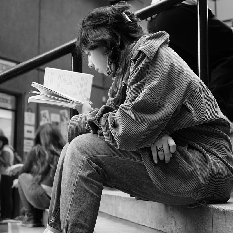 Undergraduate student reading a book.